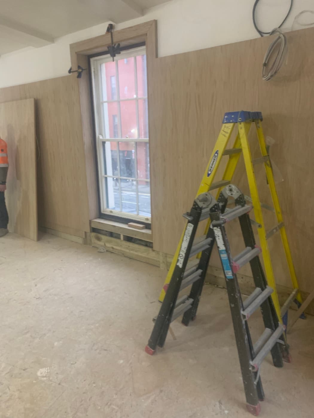 During the fit-out: Wall panelling going in at the front window, and the finished banquette seating.