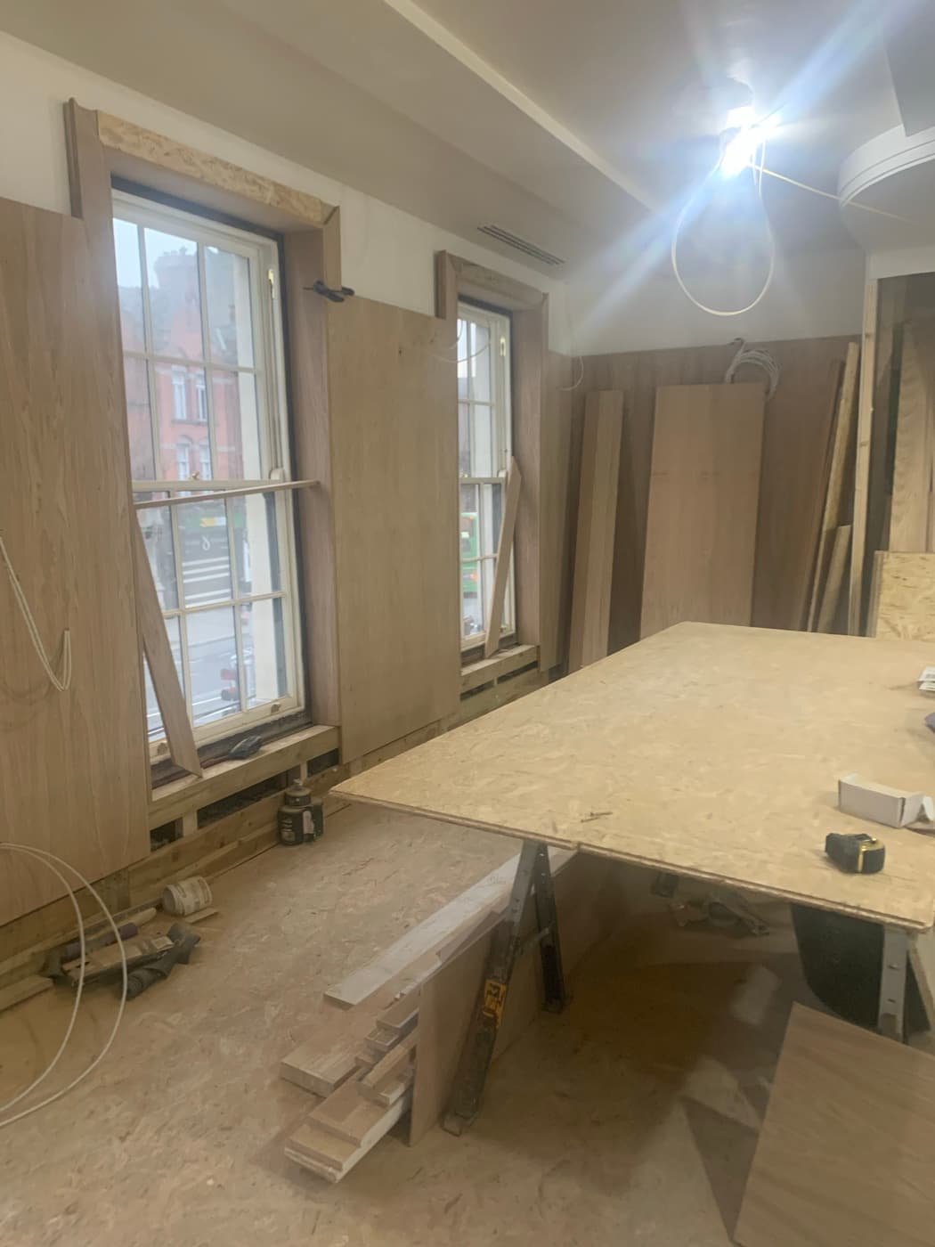 During the fit-out: The front room by the sash windows during the build, and finished with high tables and bar seating.